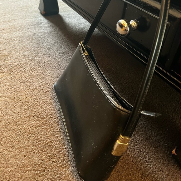 Black handbag. Silver coloured details on zip, feet on bottom and side detail - Picture 3 of 8